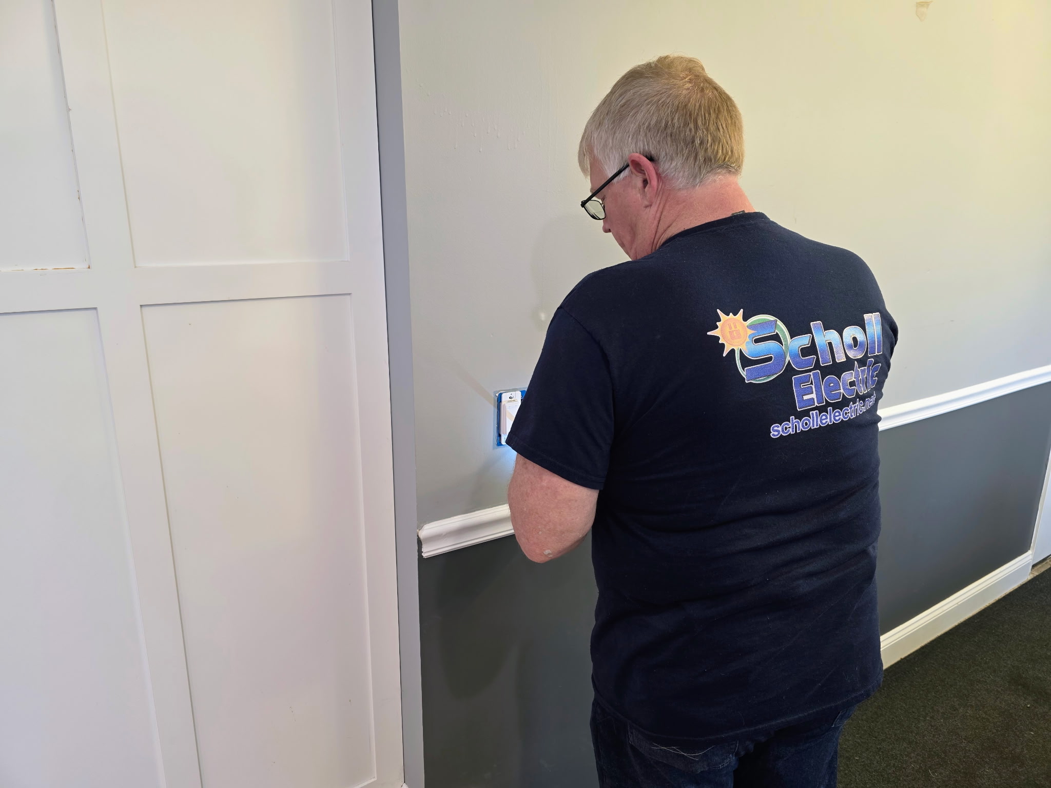 Electrician repairing an outlet