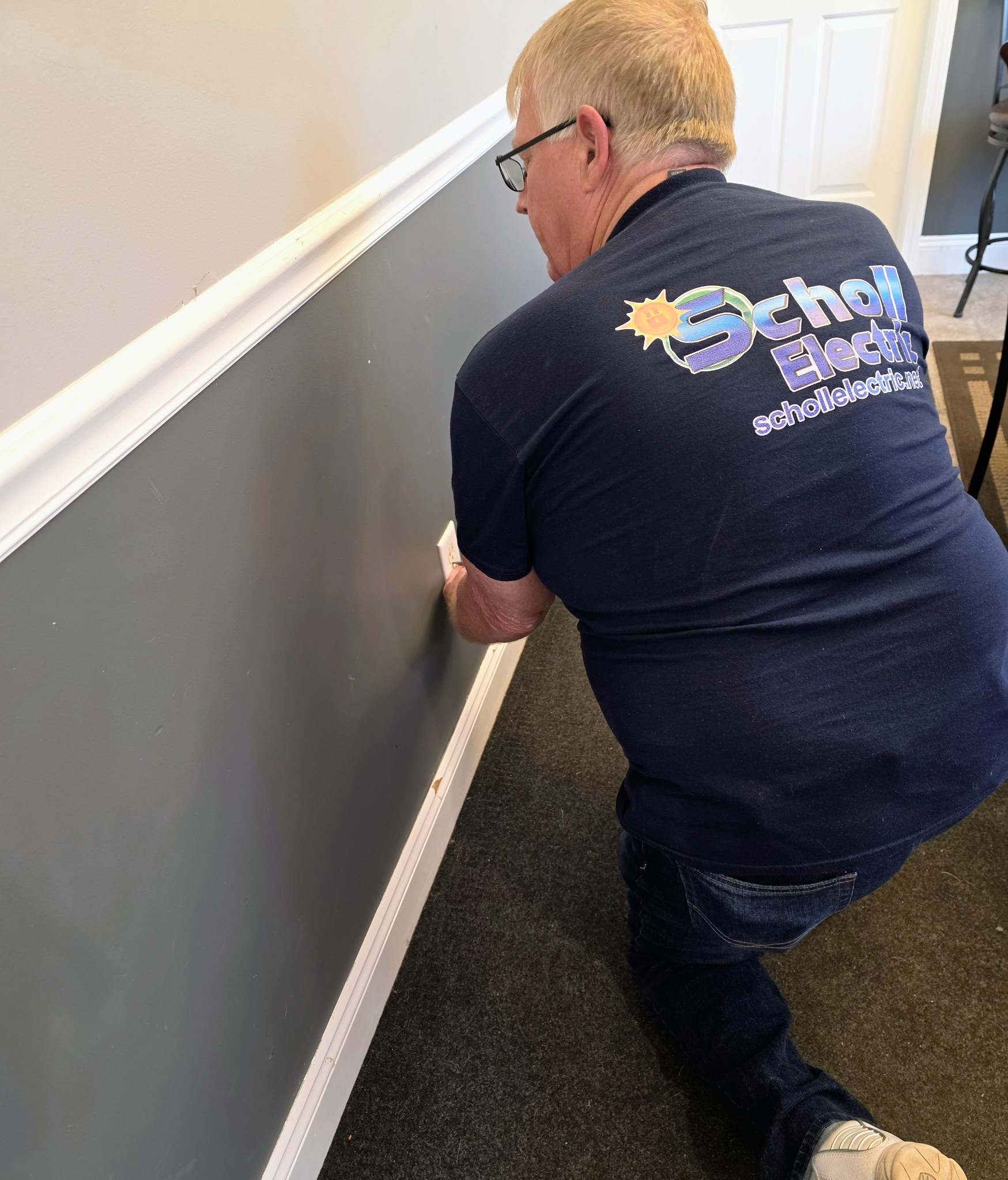 Electrician repairing an outlet